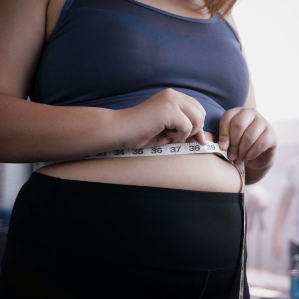 Person measuring their waist